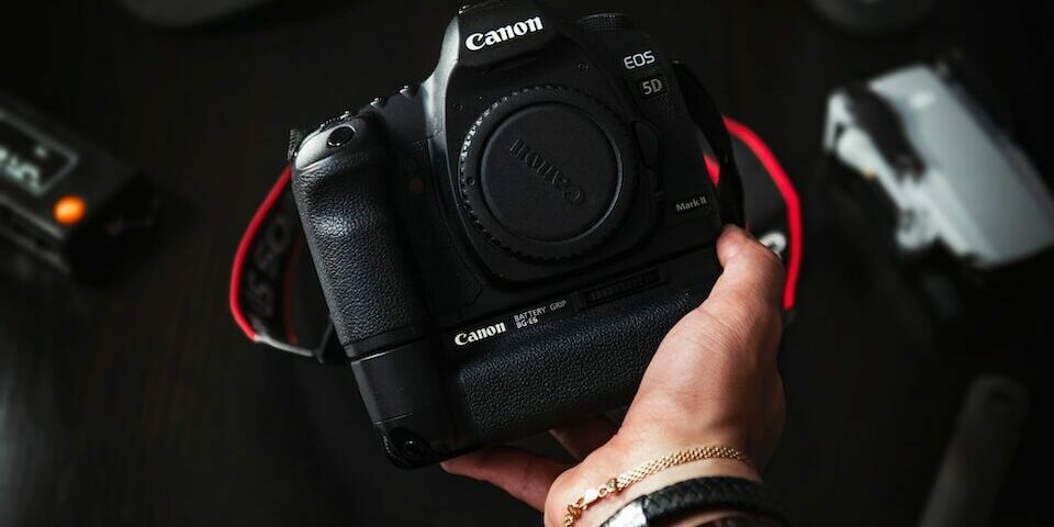 person holding black nikon dslr camera