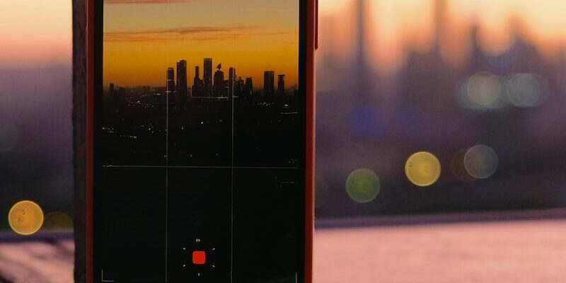 black iphone 4 on brown wooden table