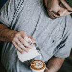 man in gray crew-neck T-shirt making cappuccino